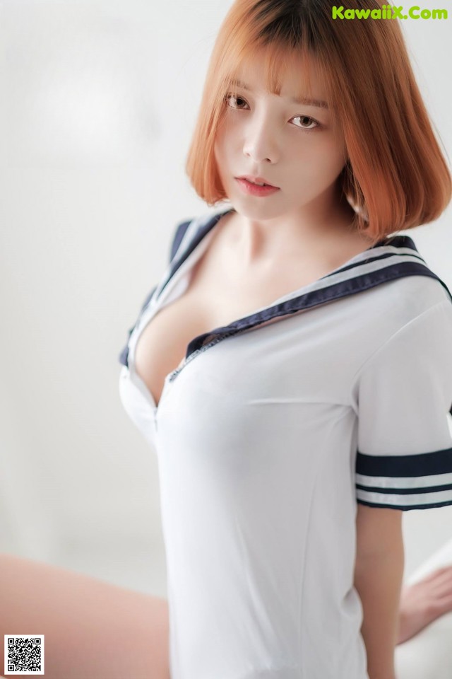 A woman in a white shirt and blue and white striped shirt.