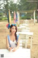 A woman sitting at a table on a beach.