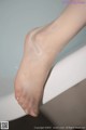 A close up of a woman's bare feet in a bathtub.