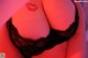 A close up of a woman wearing a black bra and panties.