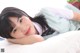 A young woman laying on top of a white pillow.