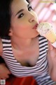 A woman is eating an ice cream cone. 